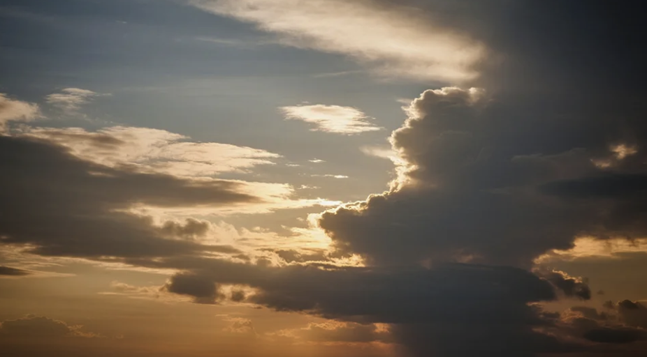 Dramatic sky with various cloud formations and sunlight breaking through - excellent example for landscape and weather pattern documentation in nature journaling